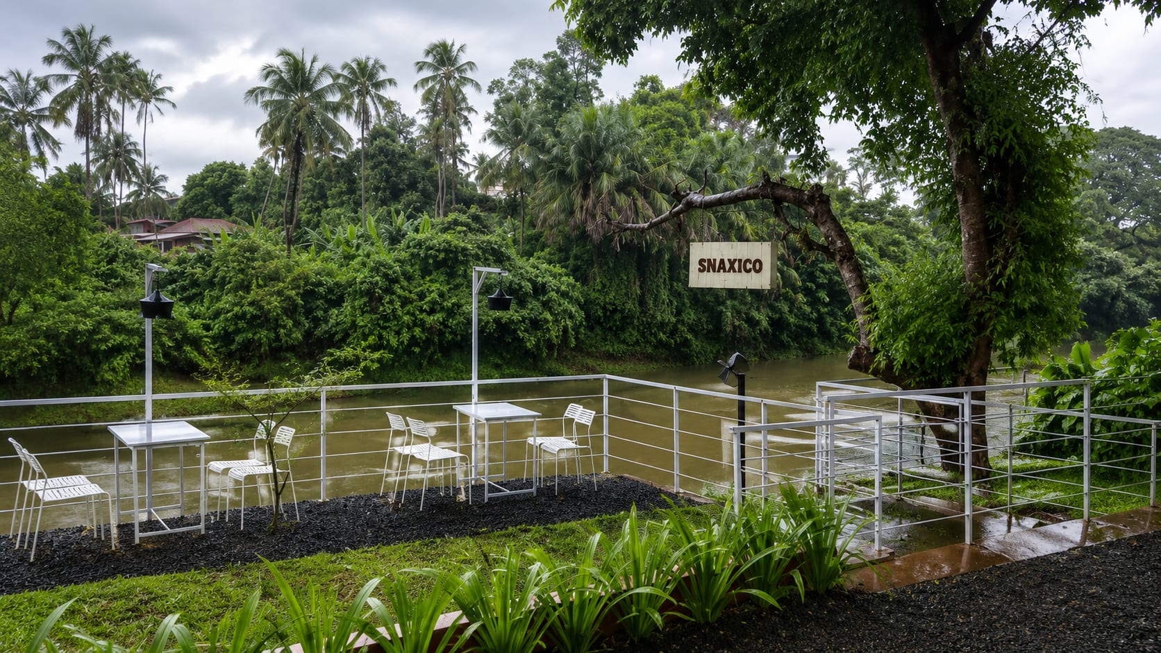 Riverside deck overlooking the water with white balustrades and hanging Snaxico sign