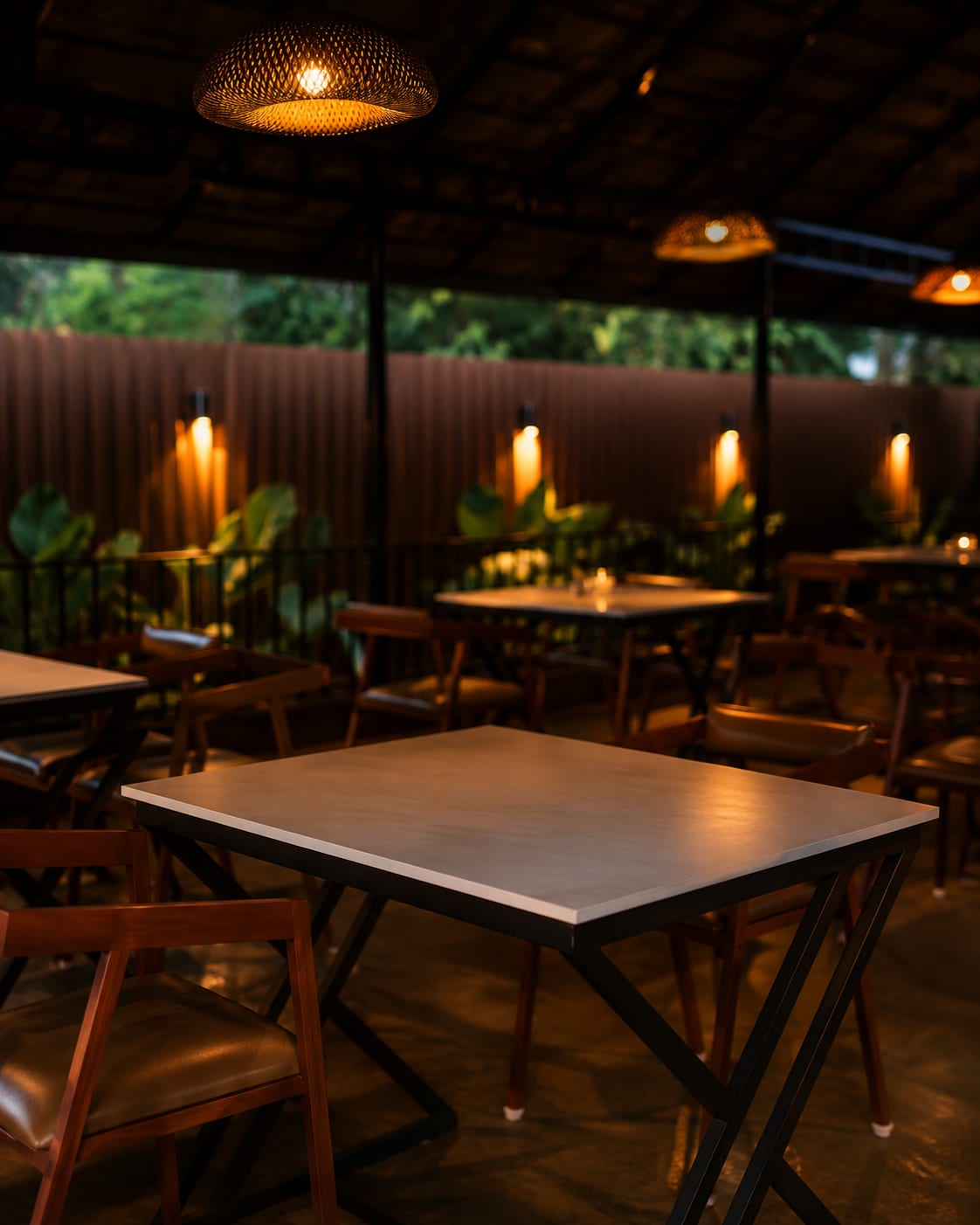 Warm ambient dining tables under woven rattan dome lights and wall sconces